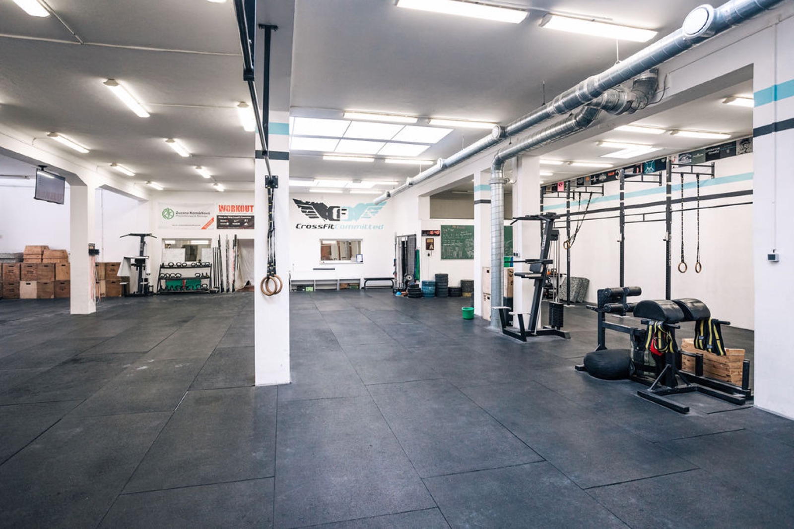 The open, members-only training floor at CrossFit Committed with the rig and plyo boxes