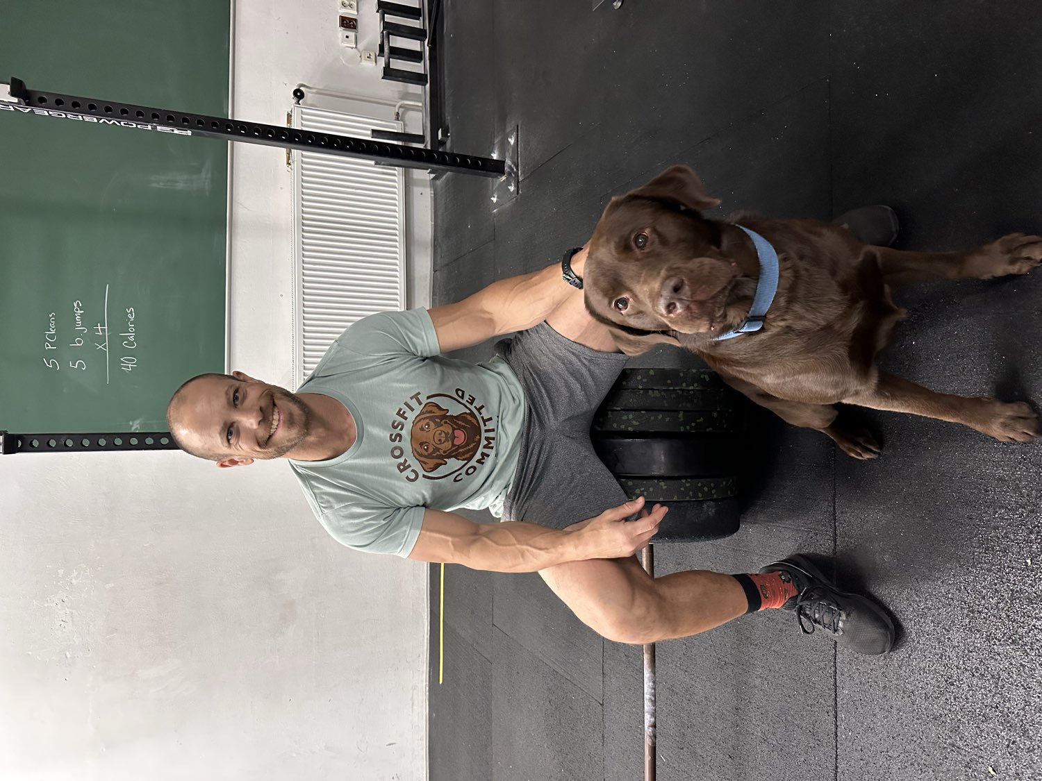 Joey Scafidi, head coach and owner, at CrossFit Committed with his dog